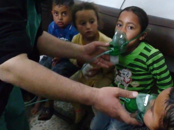 FILE - In this file image taken from video obtained from the Shaam News Network, posted on April 16, 2014, an anti-Bashar Assad activist group, which has been authenticated based on its contents and other AP reporting, children are seen receiving oxygen in Kfar Zeita, a rebel-held village in Hama province some 200 kilometers (125 miles) north of Damascus. A toxic chemical, almost certainly chlorine, was used "systematically and repeatedly" as a weapon in attacks on villages in northern Syria earlier this year, the global chemical weapons watchdog said Wednesday, Sept. 10, 2014. (AP Photo/Shaam News Network, File)