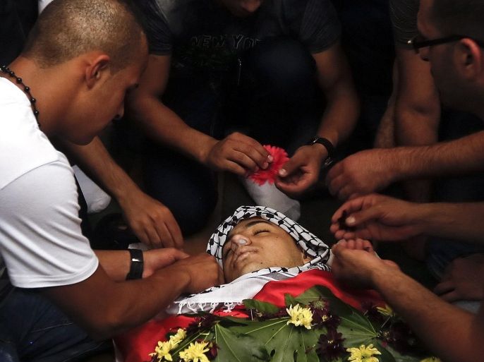 Palestinian mourn the death of Laith al-Khaldi, 18, during his funeral in the Jalazoun refugee camp, West Bank, 01 August 2015. Al-Khaldi was shot by Israeli soldiers during clashes that broke out following an arson attack on two Palestinian houses on the outskirts of the village of Douma, south of Nablus, 31 July, in which a Palestinian infant was killed.