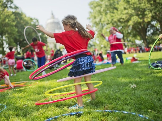 UNITED STATES - JULY 7: Olivia Yost, 5, of Pittsburgh, hula hoops during a 'play-in' protest by kids and mothers in Upper Senate Park organized by Moms Clean Air Force, July 7, 2015. About 400 gathered to support the EPA's Clean Power Plan and call attention to climate change and air pollution.