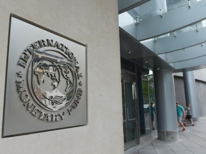 The seal of the International Monetary Fund is seen on a headquarters building in Washington, DC on July 5, 2015. The euro was dropping against the dollar after early results of the Greece bailout referendum suggested the country rejected fresh austerity demands from EU-IMF creditors. AFP PHOTO/MANDEL NGAN