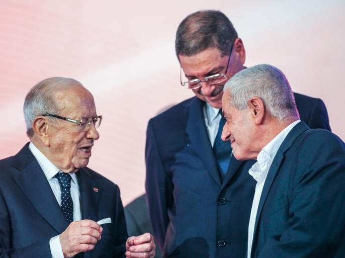 TUNIS, TUNISIA - MAY 1: Tunisian Prime Minister Habib Essid (C) and Tunisian President Beji Caid Essebsi (L) and secretary general of Tunisian General Labour Union (UGTT) Hussein Al-Abbasi (R) attend an event of May Day, International Workers' Day, at Palace of Congresses in Tunis, Tunisia on May 01, 2015.