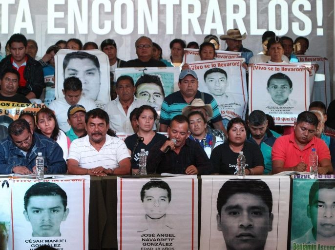 Parents of the 43 young people, who went missing a year ago in Iguala, Mexico, and students of Ayotzinapa school hold pictures of the missing during a press conference in Mexico City, Mexico, 06 September 2015. Parents and studens asked for a private meeting with Mexican President Enrique Pena Nieto and the extension of the investigations by the Mexican government after the experts of the Inter American Commission of Human Rights presented their report in the case on 06 September 2015 after six months of work.