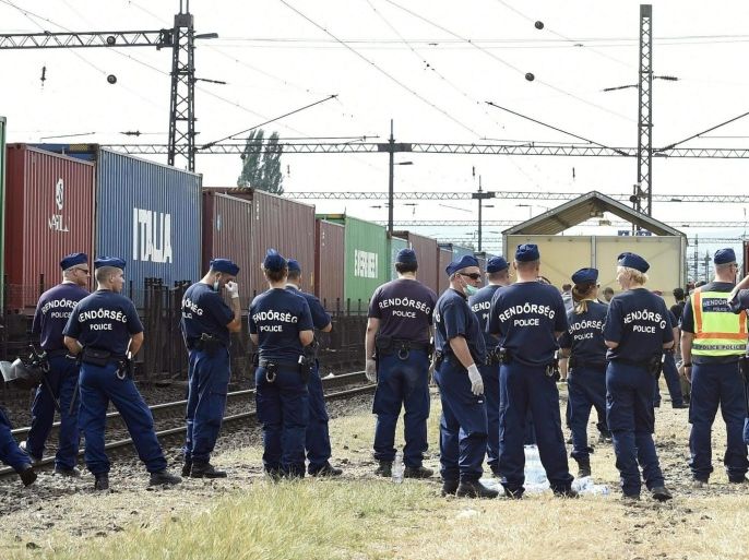 Hungarian police detains migrants at the Railway Station in Bicske, Hungary, 03 September 2015. Hundreds of migrants rushed the platforms in Budapest after Hungarian police opened the city's Keleti station, which had been blocked to migrants since 01 September. Hungary's railway service said there were no trains headed to Western Europe for the time being. Thousands of refugee - many of whom have traveled from Africa and the Middle East in the hopes of reaching countries like Germany and Sweden - have been stranded at the station. EPA/HERBERT P. OCZERET