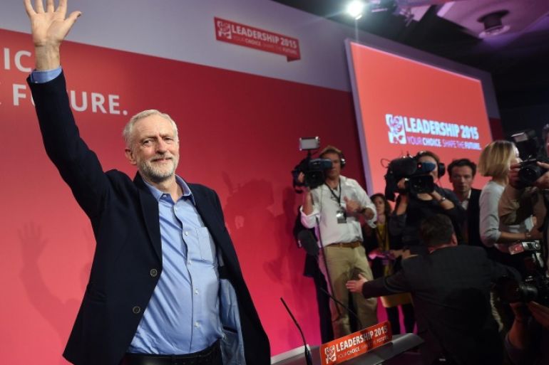 New Labour leader Jeremy Corbyn (L) waves following his announcement as the party's new leader at a Labour special conference in London, Britain, 12 September 2015. Veteran left-wing politician Corbyn was elected in a vote that was expected to swing the party to the left.