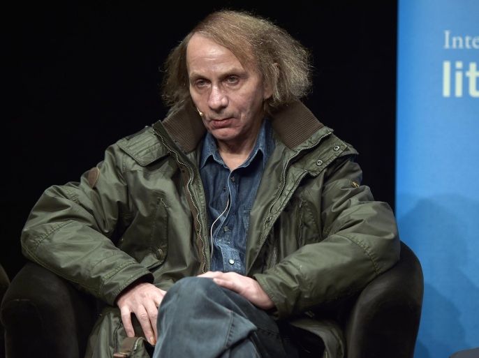 French novelist and poet Michel Houellebecq watches the audience prior to a reading of his latest book in Cologne, Germany, Monday, Jan. 19, 2015. The controversial author appears in public for the first time after his book "Soumission" (submission) was published on the day of the Charlie Hebdo shooting in Paris. A cartoon of Houellebecq was published on the magazine's cover page that day, giving attention to his book, describing a future France where a Muslim president is ruling the country according to Islamic law. (AP Photo/Martin Meissner)