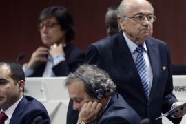FILE - In this May 29, 2015 file photo FIFA president Joseph S. Blatter, right, walks past Prince Ali bin al-Hussein, left, and UEFA President Michel Platini, center, during the 65th FIFA Congress held at the Hallenstadion in Zurich, Switzerland. On Friday, Sept. 25, 2015 Swiss attorney general opened criminal proceedings against FIFA President Sepp Blatter. (Walter Bieri/Keystone via AP)