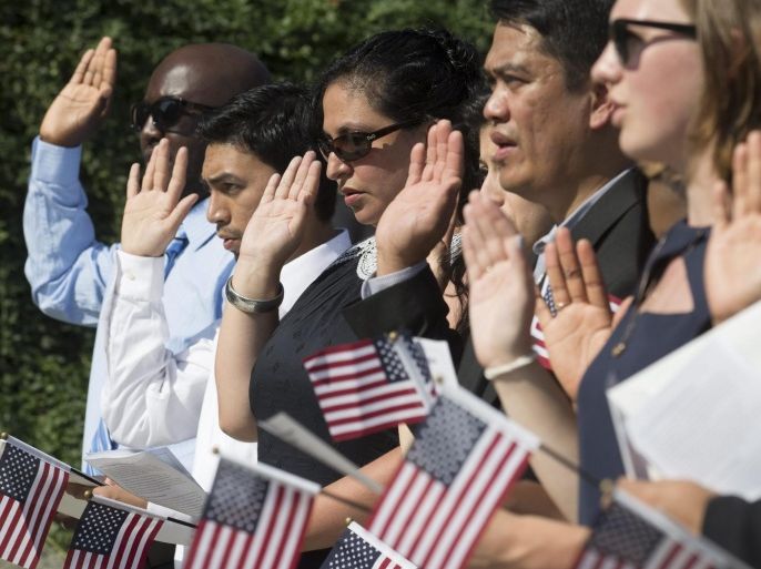 Participants take the Oath of Allegiance during a naturalization ceremony held by US Citizenship and Immigration Services, at Martin Luther King Jr. Memorial in Washington DC, USA, 28 August 2015. 28 people from 30 countries became US citizens in the ceremony held to honor the 52nd anniversary of Martin Luther King Jr.'s 'I Have a Dream' speech.
