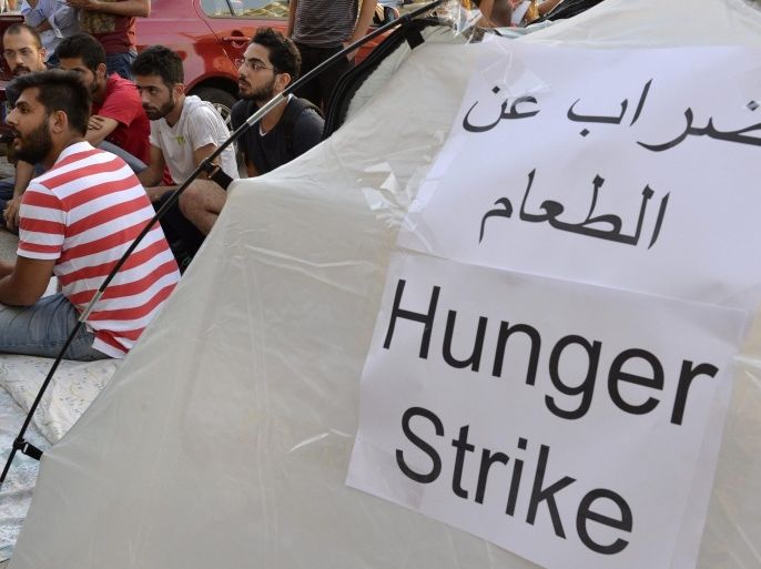 Lebanese 'You Stink' activists sit in front of their tent during a hunger strike against minister Mohammed Machnouk, calling for him to resign over a rubbish disposal crisis, in front of the Environment Ministry in downtown Beirut, Lebanon, 03 September 2015. Lebanese people's frustration with the Government's internecine conflicts which have paralyzed the political process has manifested in days of protests sparked by mounting garbage piled on streets, but becoming a criticism of the political class in general, seen as corrupt, cronyist and self serving.