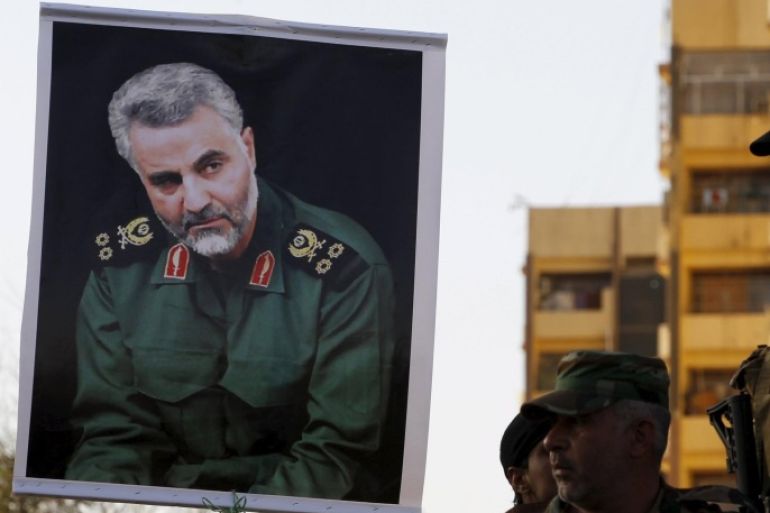 Members from Hashid Shaabi hold a portrait of Quds Force Commander Major General Qassem Suleimani during a demonstration to show support for Yemen's Shi'ite Houthis and in protest of an air campaign in Yemen by a Saudi-led coalition, in Baghdad March 31, 2015. Saudi troops clashed with Yemeni Houthi fighters on Tuesday in the heaviest exchange of cross-border fire since the start of a Saudi-led air offensive last week, while Yemen's foreign minister called for a rapid Arab intervention on the ground. REUTERS/Thaier Al-Sudani