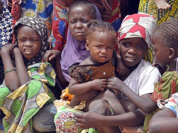 Children fleeing from Boko Haram attacks gather at Gudumariya Refugees Camp, Diffa in Niger Republic on March 13, 2015. Governor of northeastern Nigerian Borno State Kashim Shettima recently visited refugee camps where Nigerians fleeing from Boko Haram Islamists attacks are sheltered in Diffa province of Niger Republic. More than 13,000 people have been killed and some 1.5 million made homeless in the Boko Haram conflict since 2009, while recent cross-border attacks from Boko Haram bases in Nigeria on neighbouring countries have increased security fears. AFP PHOTO/OLATUNJI OMIRIN