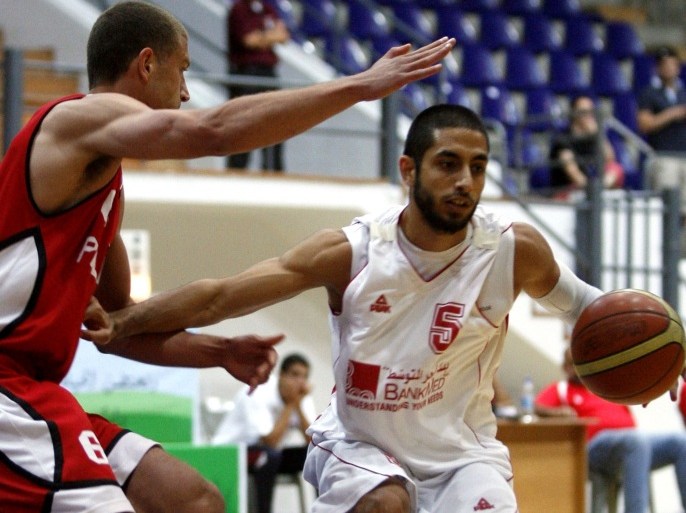 Palestine's Jamal William Abu-Shamala (L) vies for the ball against Lebanon's Miguel Raymondo Martinez (R) during their basketball match in the West Asian Basketball (WABA) championship, in the Jordanian capital, Amman on June 15, 2012.