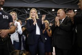 Leader of French far-right political party National Front (FN) Marine Le Pen (C) sings the French national anthem with security staff during the National Front summer conference, in Marseille, France, 06 September 2015.