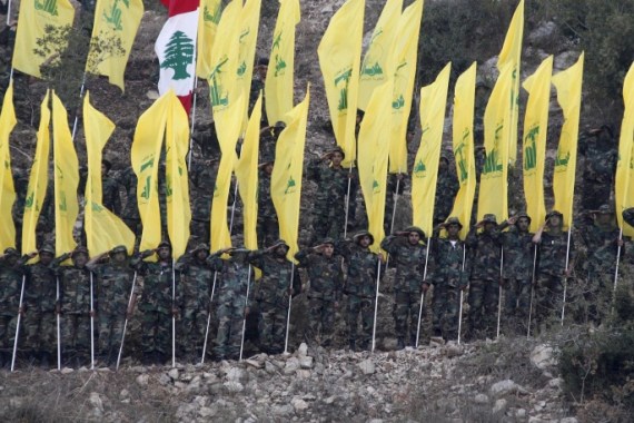 Members of Lebanon's Hezbollah wave Hezbollah and Lebanese flags during a rally marking the ninth anniversary of the end of Hezbollah's 2006 war with Israel, in Wadi al-Hujeir, southern Lebanon August 14, 2015. REUTERS/Aziz Taher