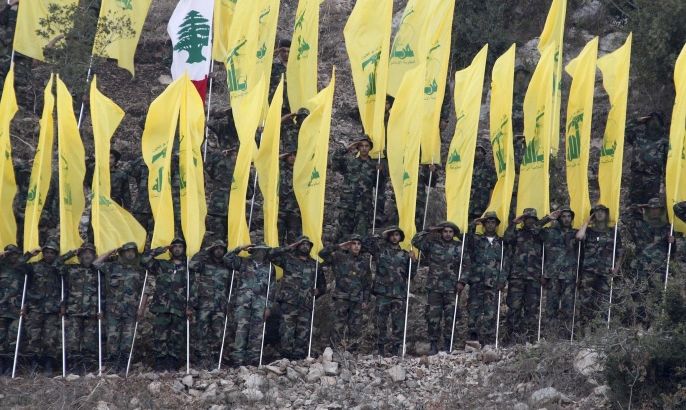 Members of Lebanon's Hezbollah wave Hezbollah and Lebanese flags during a rally marking the ninth anniversary of the end of Hezbollah's 2006 war with Israel, in Wadi al-Hujeir, southern Lebanon August 14, 2015. REUTERS/Aziz Taher