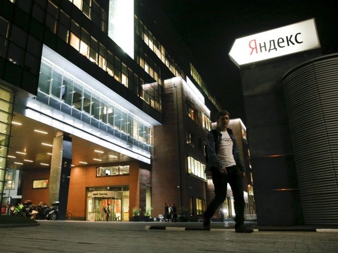 A man walks outside the headquarters of Yandex company in Moscow, September 14, 2015. Russia's anti-monopoly agency said on Monday Google Inc was abusing its dominant market position in the country and could face penalties, in a case launched by its Russian competitor Yandex. The sign (R) reads: "Yandex." REUTERS/Maxim Zmeyev