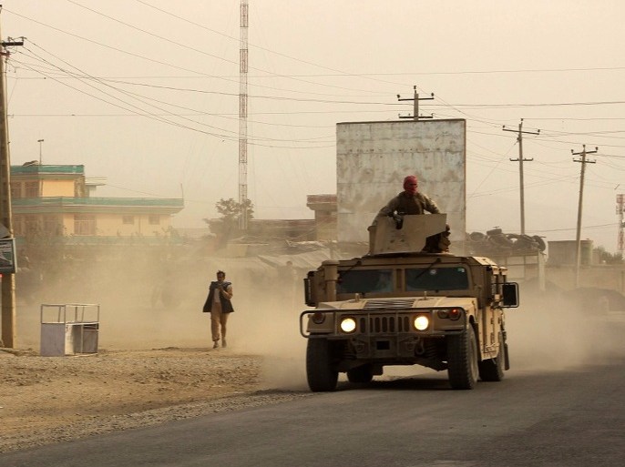 -, AFGHANISTAN : Afghan security forces travel in a Humvee vehicle, as battles were ongoing between Taliban militants and Afghan security forces, in Kunduz, capital of northeastern Kunduz province on September 28, 2015. The Taliban are in control of around half of Kunduz, Afghanistan's fifth largest city, a senior police official said September 28. Sayed Sarwar Hussaini, police spokesman for the northeastern Kunduz province, told a news conference: "Around half the city has fallen into the hands of Taliban insurgents." AFP PHOTO