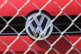 A Volkswagen diesel sits behind a security fence on a storage lot near a VW dealership Wednesday, Sept. 23, 2015, in Salt Lake City. Volkswagen CEO Martin Winterkorn resigned Wednesday, days after admitting that the world's top-selling carmaker had rigged diesel emissions to pass U.S. tests during his tenure. (AP Photo/Rick Bowmer)