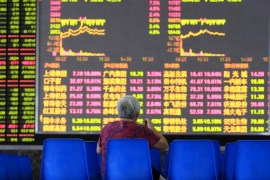 An investor looks at an electronic board showing stock information at a brokerage house in Shanghai, August 25, 2015. China's major stock indexes sank more than 6 percent in early trade on Tuesday, after a catastrophic Monday that saw Chinese exchanges suffer their biggest losses since the global financial crisis, destabilizing financial markets around the world. REUTERS/Aly Song