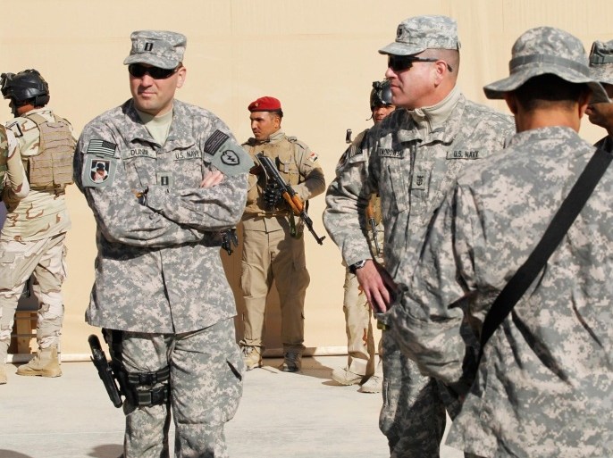 U.S. military personnel gather before the start of a ceremony to mark the hand over of the al-Asad airbase to the Iraqi army in Iraq's western province of Anbar December 7, 2011.