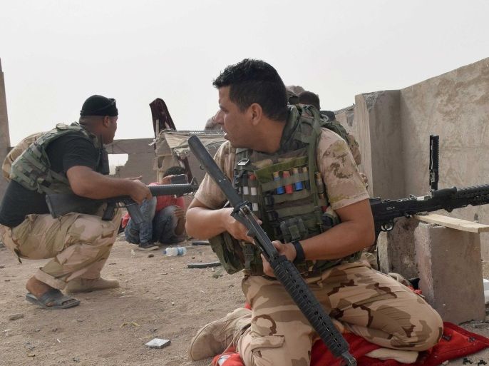 In this Saturday, Sept. 12, 2015 photo, Iraqi security forces backed by Sunni and Shiite volunteers clash with Islamic State group militants at the front line in the suburbs of Ramadi, Anbar province, Iraq. (AP Photo)