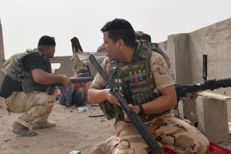 In this Saturday, Sept. 12, 2015 photo, Iraqi security forces backed by Sunni and Shiite volunteers clash with Islamic State group militants at the front line in the suburbs of Ramadi, Anbar province, Iraq. (AP Photo)