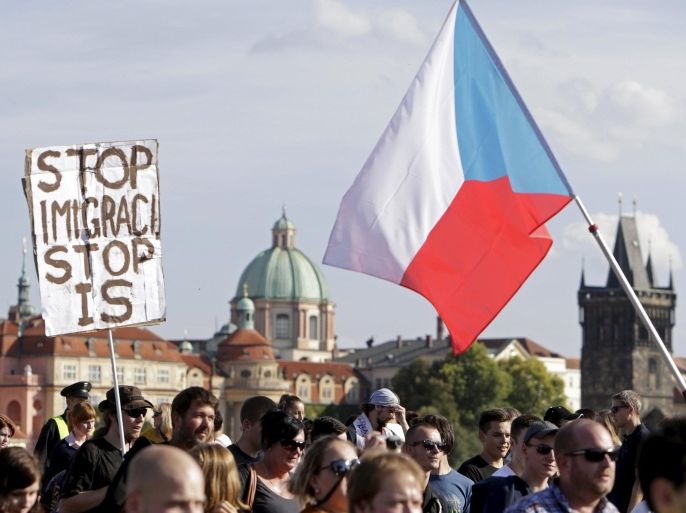 Demonstrators march during an anti-immigrants rally in Prague, Czech Republic, September 12, 2015. The banner reads: "Stop immigration, stop IS". REUTERS/David W Cerny