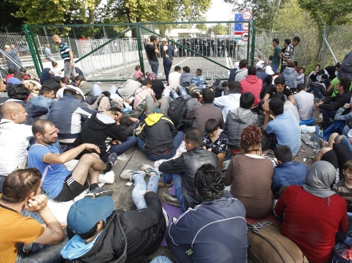 Migrants wait at the Horgos 2 border crossing at the Serbia-Hungary border, 15 September 2015. Hungary has sealed the last gap in the barricade along its border with Serbia, closing the passage to thousands of refugees and migrants still waiting on the other side.