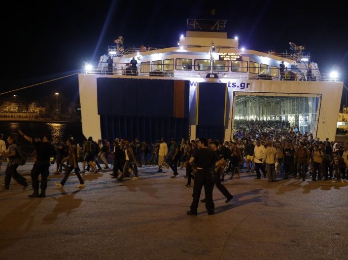Syrian migrants disembark from the catamaran Terra Jet at the Athens' port of Piraeus, on Tuesday, Sept. 1, 2015. About 1,800 refugees arrived from the northeastern Aegean island of Lesbos as the country has been overwhelmed by record numbers of migrants this year. (AP Photo/Thanassis Stavrakis)