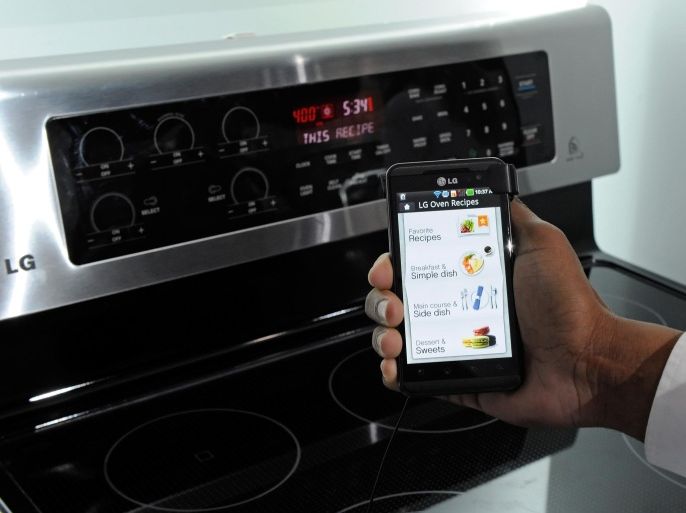 LAS VEGAS, NV - JANUARY 11: A smartphone sending instructions to an oven using LG's newest Smart ThinQ technology is demonstrated at the LG Electronics booth at the 2012 International Consumer Electronics Show at the Las Vegas Convention Center January 11, 2012 in Las Vegas, Nevada. LG's line of smart home appliances coming out in 2012, have improved connectivity between them and other devices like phones and TVs, allowing for easier control and monitoring of the devices. CES, the world's largest annual consumer technology trade show, runs through January 13 and features more than 3,100 exhibitors showing off their latest products and services to about 140,000 attendees.