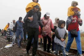Migrants walk along a rail track in the rain from Roszke to Szeged in Hungary, September 10, 2015. More than 170,000 people have crossed into Hungary since the beginning of the year, fleeing war, discrimination and poverty in the Middle East and Africa in the hope of finding refuge in the richest countries of the European Union. Hungarian authorities, following EU law, are trying to keep them in camps but thousands have managed to get to Austria and Germany by train and coach. REUTERS/Laszlo Balogh