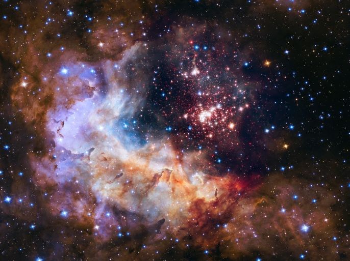 This undated photo provided by NASA shows an image taken by the Hubble Space Telescope showing a breeding ground for stars in the Constellation Carina, about 20,000 light years from Earth. Friday, April 24, 2015, marks the 25th anniversary of Hubble's launch. (NASA/ESA/Hubble Heritage Team/A. Nota, Westerlund 2 Science Team via AP)