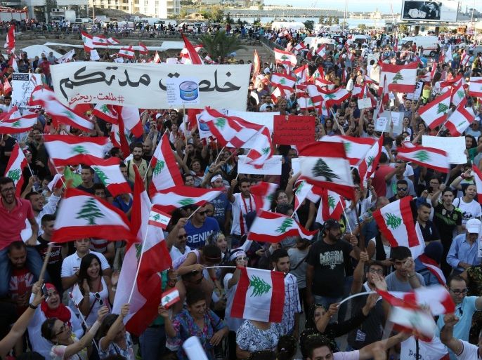 Lebanese anti-government protesters wave Lebanese flags and placards during a demonstration in Martyrs' Square, downtown Beirut, Lebanon, Saturday, Aug. 29, 2015. Thousands of people staged the largest of the demonstrations that began last week over garbage piling up in the streets of Beirut following the closure of a main landfill. The government's failure to resolve the crisis has evolved into wider protests against a political class that has dominated Lebanon since the end of the country's civil war in 1990 and a government that has failed to provide even basic services to the people. (AP Photo/Bilal Hussein)