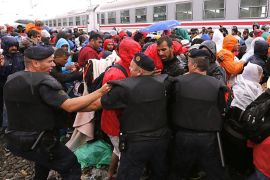 Croatian police tries to hold back migrants pushing to get aboard a train bound for Hungary and Austria at a railway station at the Croatian-Serbian border, near Tovarnik, Croatia, 20 September 2015. More and more migrants arrive in Croatia on alternative routes to enter the European Union. Serbia's border with Croatia has become the latest flashpoint in Europe's refugee crisis as migrants sought alternative routes to Western Europe after Hungary slammed its doors shut. Hungary on 15 September sealed the last gap in the barricade along its border with Serbia, closing the passage to thousands of refugees and migrants still waiting on the other side and some groups decided to pass over Croatia.