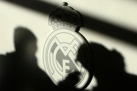 Shadows of reporters are seen on Real Madrid's logo during a news conference of Real Madrid new coach Juande Ramos ahead of their Champions League match against Zenit Saint Petersburg in Madrid December 9, 2008. Real Madrid appointed their 11th coach in 10 years on Tuesday when former Sevilla and Tottenham Hotspur manager Ramos replaced Bernd Schuster.