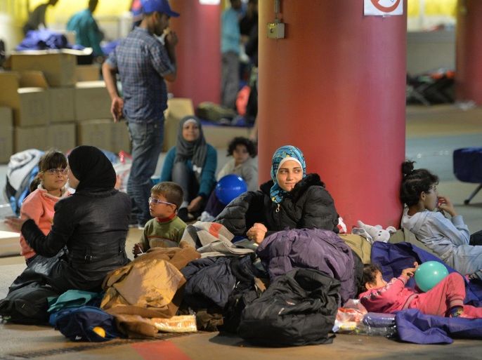 Refugees rest in a parking garage in the main rail station in Salzburg Austria, Sunday, Sept. 13, 2015. At least four countries Friday firmly rejected a European Union plan to impose refugee quotas to ease a worsening migrant crisis that Germany's foreign minister said was "probably the biggest challenge" in the history of the 28-nation bloc. (AP Photo/Kerstin Joensson)