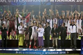 Qatar soccer team members celebrate with trophy after wining AFC U-19 Championship final against North Korea in Yangon, Myanmar, 23 October 2014. Qatar became Asian Football Confederation under-19 champion after wining with the result 1-0.