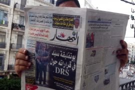 FAB02 - Algiers, -, ALGERIA : An Algerian man reads a local newspaper, En-Nahar, bearing a picture for the first time of former Algerian intelligence chief General Mohamed Mediene, better known as General Toufik, on the front cover in the capital, Algiers, on September 13, 2015, after Algerian leader Abdelaziz Bouteflika replaced his powerful intelligence chief with his deputy, General Athmane "Bachir" Tartag. AFP PHOTO / FAROUK BATICHE