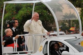 Pope Francis waves from the Popemobile as he is driven from Jose Marti airport to the Havana's downtown, on September 19, 2015. Pope Francis on Saturday urged the United States and Cuba to build on their nascent reconciliation as he arrived in Havana for the first leg of a high-profile trip that will also take him to America. AFP PHOTO/ADALBERTO ROQUE
