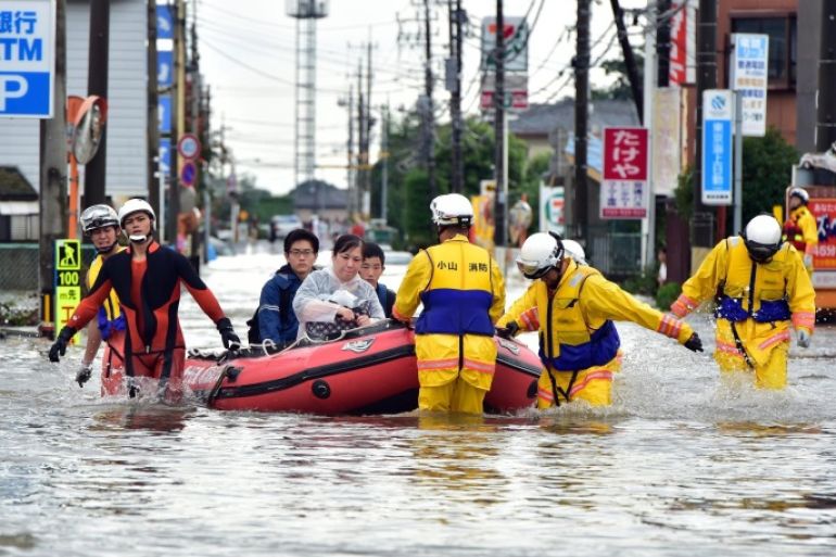 Rescue workers transport evacuees in a rubber boat through floodwaters at Oyama in Tochigi prefecture, north of Tokyo on September 10, 2015. Authorities in central Japan ordered tens of thousands to flee their homes after torrential rains flooded rivers and triggered landslides, with one person missing after a mudslide buried houses. The Japan Meteorological Agency issued special downpour warnings for Tochigi and Ibaraki prefectures, north of Tokyo, urging vigilance against mudslides and flooding. AFP PHOTO / Yoshikazu TSUNO