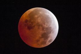 A lunar eclipse is seen on Saturday, April 4, 2015, in Placerville, Calif. Early risers in the western U.S. and Canada should have been able to catch a glimpse before dawn Saturday. The moment when the moon was completely obscured by Earth's shadow lasted only a few minutes, making it the shortest lunar eclipse of the century. (AP Photo/The Sacramento Bee, Randall Benton)