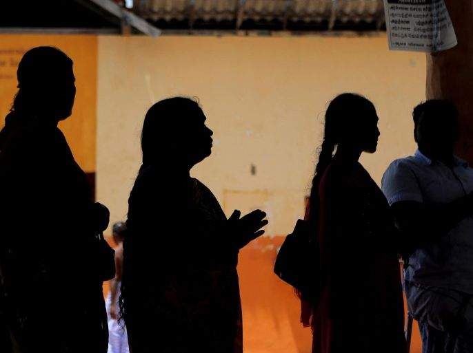 Sri Lanka's ethnic Tamil war victims pray at a Hindu temple in Mullivaikkal, about 335 kilometers (208 miles) northeast of Sri Lanka, Monday, May 18, 2015. Sri Lanka's ethnic Tamil politicians and a few civilians have gathered under heavy surveillance at a ceremony to pay homage to thousands of people killed in the final days of a decades-long civil war that ended in 2009. (AP Photo/Eranga Jayawardena)