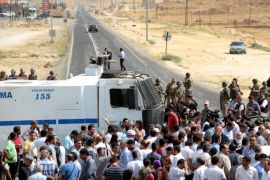 Turkish security forces block a road to stop a convoy, carrying a delegation of the pro-Kurdish Peoples' Democratic Party (HDP), near the southeastern town of Midyat, Turkey, September 9, 2015. A deteriorating security situation in Turkey's mainly Kurdish southeast where a ceasefire between government forces and Kurdish insurgents has broken down, will make it difficult to hold an election planned for November, the head of the pro-Kurdish Peoples' Democratic Party (HDP) said on Wednesday. The HDP delegation, including the party's co-chair Selahattin Demirtas, was stopped by the security forces while on their way to the southeastern town of Cizre. According to local media, Cizre is under a curfew for five days because of clashes between PKK militants and Turkish security forces. REUTERS/Sertac Kayar