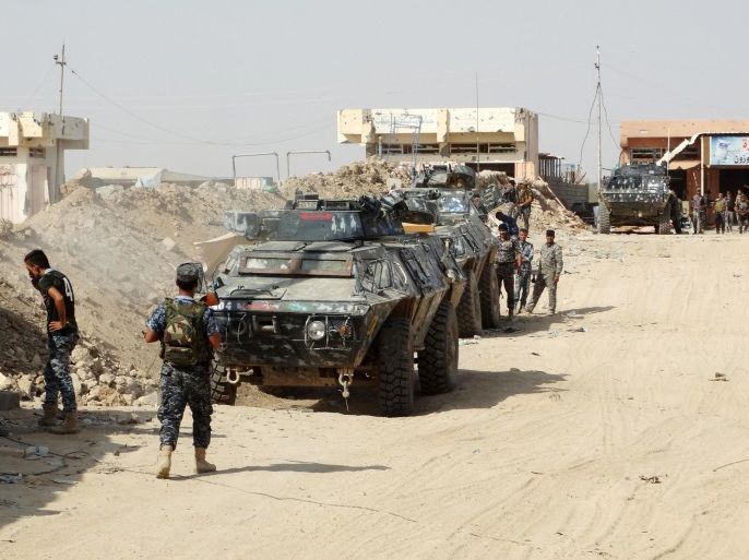 In this Thursday, Aug. 27, 2015 photo, Iraqi security forces, backed by Sunni and Shiite volunteers clash with Islamic State group militants at the front line in the eastern suburbs of Ramadi, Anbar province, Iraq. (AP Photo)