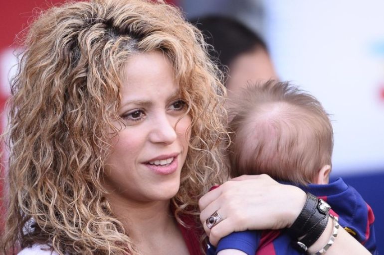 FILE - In this April 18, 2015 file photo, Colombian singer Shakira holds her son Sasha prior to a Spanish La Liga soccer match between FC Barcelona and Valencia at the Camp Nou stadium in Barcelona, Spain. On Wednesday, July 29, Shakira posted on Twitter and Facebook a video titled "Happy 6 months Sasha!" in which she appears holding Sasha in front of a soccer ball. The child raised his leg and gently kicked the ball. (AP Photo/Manu Fernandez, File)