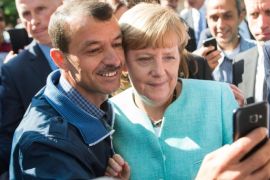 German Chancellor Angela Merkel (R) has a selfie taken with a refugee during a visit to a refugee reception centre in Berlin, Germany, 10 September 2015. Germany can deal with the arrival of hundreds of thousands of refugees without cutting social welfare benefits or raise taxes, Vice Chancellor Sigmar Gabriel said on 10 September, during a debate in parliament on next year's budget. Germany expects 800,000 asylum seekers this year, four times more than last year and more than any other country in the European Union, which is split on how to deal with the biggest refugee crisis since World War II.