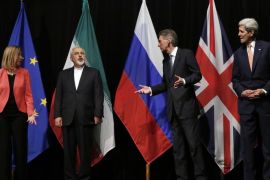 FILE - In this file photo, British Foreign Secretary Philip Hammond, second right, U.S. Secretary of State John Kerry, right, and European Union High Representative for Foreign Affairs and Security Policy Federica Mogherini, left, talk to Iranian Foreign Minister Mohammad Javad Zarif as the wait for Russian Foreign Minister Sergey Lavrov, not pictured, for a group picture at the Vienna International Center in Vienna, Austria. Iran sits down with the United States, Russia, Europeans and key Arab states for the first time since the Syrian civil war began to discuss the future of the war-torn country. It will also break ground by bringing President Bashar Assad’s main supporter, Iran, to the same table as its regional rivals, including Turkey and Saudi Arabia, who have been backing many of the insurgent groups. (Carlos Barria, Pool Photo via AP, File)