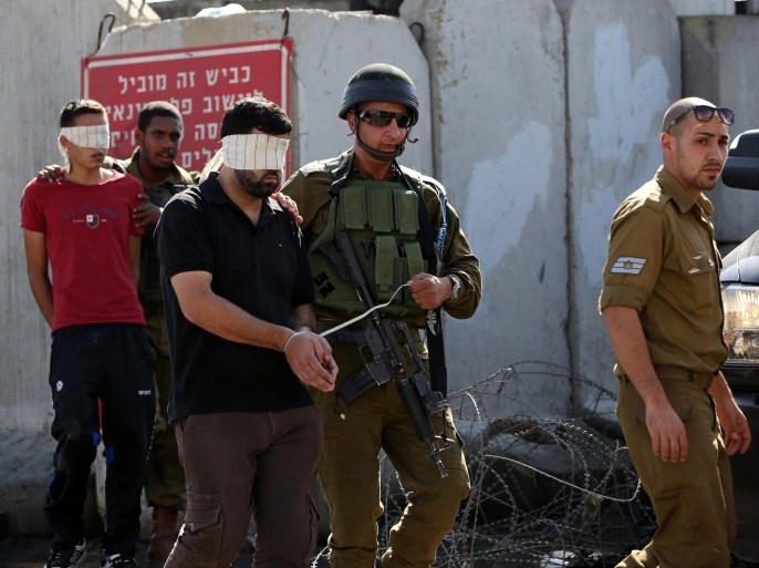 Israeli security personnel arrest Palestinian protesters during clashes in the West Bank village of Beit Omar, near Hebron, on 11 October 2015. Following the funeral of Ibrahim Awad who was shot on 09 October 2015 during the Friday protest.