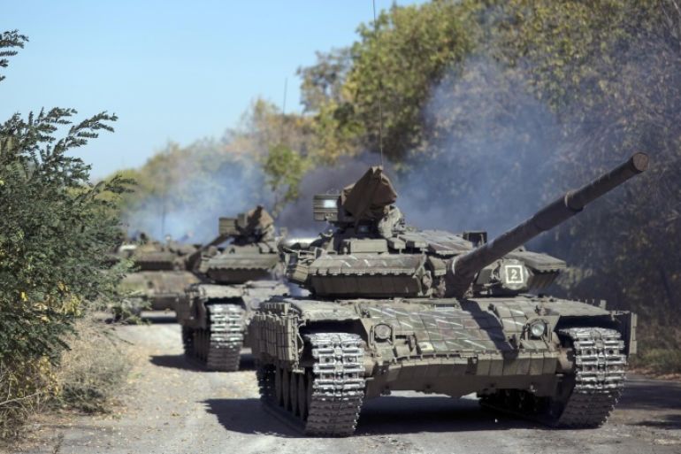 A column of Pro-Russian rebel tanks prepare to move from the front line near Oleksandrivka, Luhansk region, eastern Ukraine, Saturday, Oct. 3, 2015. A summit reviving a European push to bring peace to eastern Ukraine ended Friday with a call for the delay of contentious rebel plans to hold local elections this month and for both sides to begin a promised withdrawal of smaller-caliber weapons. (AP Photo)