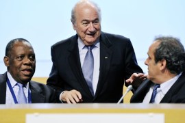FILE - In this May 25, 2012 file photo FIFA President Joseph Blatter, center, chats with Confederation of African Football, CAF, President Issa Hayatou, left, and UEFA President Michel Platini during the second day session of the 62nd FIFA Congress in Budapest, Hungary. FIFA said Thursday, Oct. 8, 2015 that African soccer leader Isaa Hayatou will serve as acting president after Blatter and Platini have been banned for 90 days. (Laszlo Beliczay/MTI via AP, file)