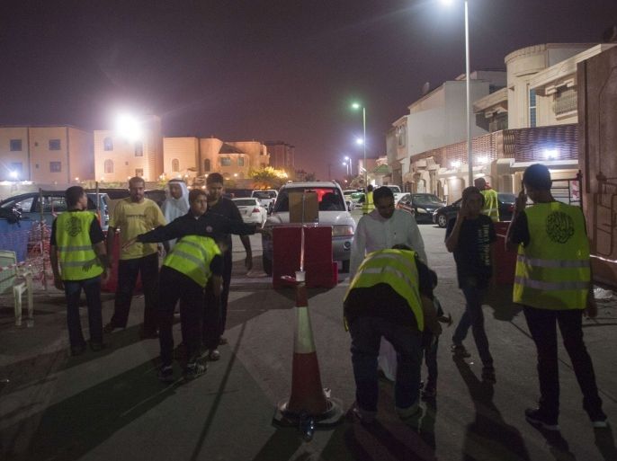 SAUDI ARABIA : Saudi Shiite worshipers are frisked by members of security as they make their way to a hussainiya, a Shiite hall used for commemorations, in the mainly Shiite coastal town of Qatif, 400 kms east of Riyadh, on October 16, 2015, two days after the start of commemorations of Ashura, one of the holiest occasions for the Shiite faith, a minority in Sunni-dominated Saudi Arabia. A gunman opened fire at a Shiite gathering in eastern Saudi Arabia, wounding four people before being killed himself, state TV said. AFP PHOTO / HUSSEIN RADWAN